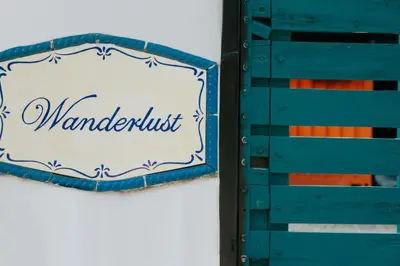 a wooden box with a sign that reads manaldust at Wanderlust in Jacó