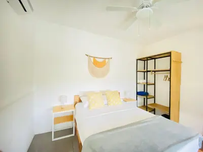 a bedroom with two beds and a ceiling fan at Altamar in Santa Teresa Beach