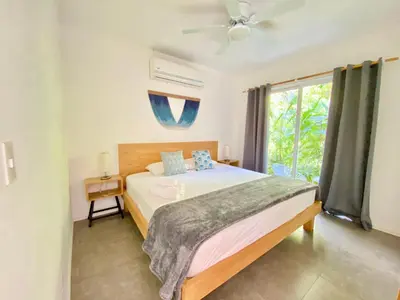 a bedroom with a large bed and a window at Altamar in Santa Teresa Beach