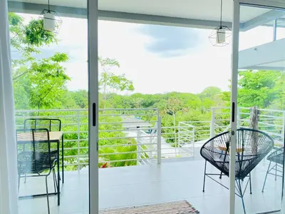 a screened porch with a table and chairs on a balcony at Altamar in Santa Teresa Beach