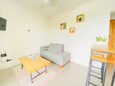 a living room with a white couch and a table at Altamar in Santa Teresa Beach