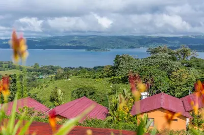 a view of a body of water from a house at Hotel Nepenthe B&B in El Castillo de La Fortuna