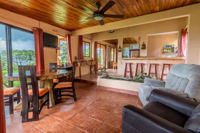 a living room with a couch and a table at Hotel Nepenthe B&B in El Castillo de La Fortuna