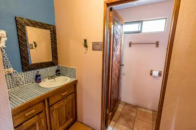a bathroom with a sink and a mirror at Hotel Nepenthe B&B in El Castillo de La Fortuna