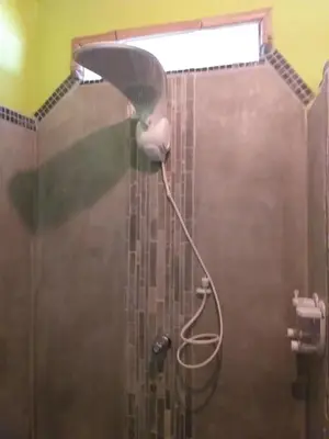 a shower with a shower head in a bathroom at Hotel Rio Celeste Finca L´ Etoile Celeste in El Achiote