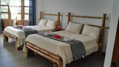 a bedroom with two beds with towels on them at Hotel Rio Celeste Finca L´ Etoile Celeste in El Achiote