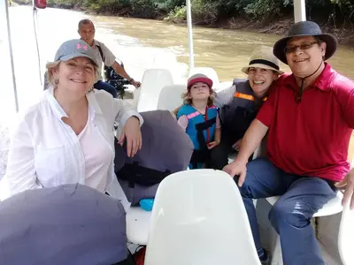 a group of people sitting on a boat in the water at Hotel Rio Celeste Finca L´ Etoile Celeste in El Achiote