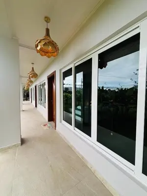 a hallway of a house with large windows at Arenal Backpackers Resort in Fortuna