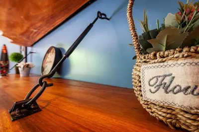 a basket on a table with a clock and a plant at Nicely Decorated Ground-Floor Unit in Front of Pool at Pacifico in Coco in Coco