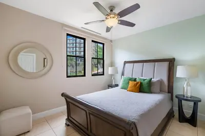 a bedroom with a bed and a ceiling fan at Renovated Condo in High-End Resort Community with Spectacular Mountain Views, Modern Design, and Beach Club Access in Coco