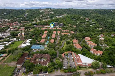 an aerial view of a city with houses and cars at Renovated Condo in High-End Resort Community with Spectacular Mountain Views, Modern Design, and Beach Club Access in Coco