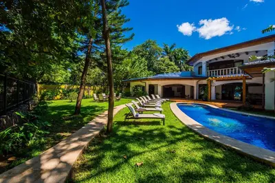 a house with a swimming pool and lounge chairs at Blue Jewel Oceanfront Private Villa in Tamarindo