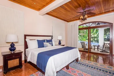 a bedroom with a bed and a ceiling fan at Blue Jewel Oceanfront Private Villa in Tamarindo