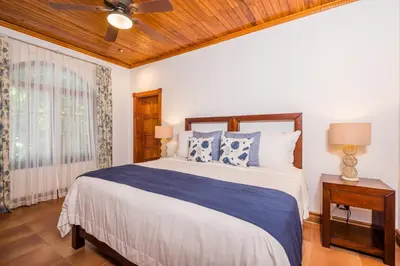 a bedroom with a bed and a ceiling fan at Blue Jewel Oceanfront Private Villa in Tamarindo
