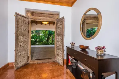 an open door in a room with a desk and a mirror at Blue Jewel Oceanfront Private Villa in Tamarindo