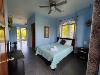 a bedroom with a bed with a pink duck on it at Hermosa Beach House in Playa Hermosa