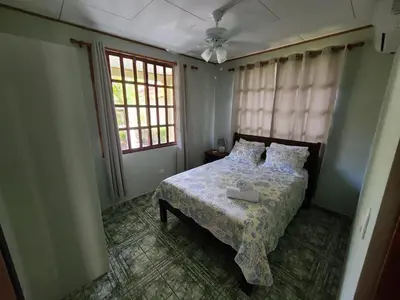 a bedroom with a bed with a box on it at Hermosa Beach House in Playa Hermosa