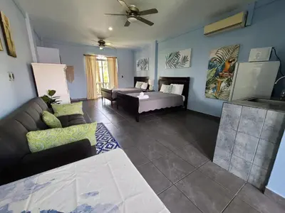 a living room with a couch and a table at Hermosa Beach House in Playa Hermosa
