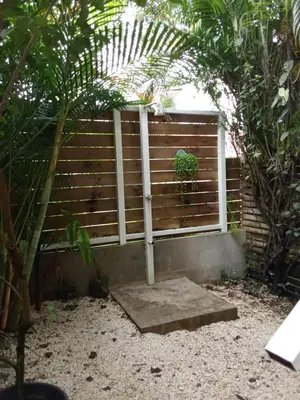 a garden with a fence with a plant in it at Casa SILURI UP in Santa Teresa Beach