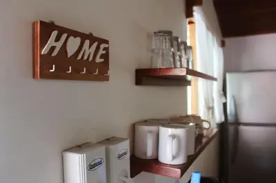 a kitchen with two appliances on a counter next to a refrigerator at Casa SILURI UP in Santa Teresa Beach