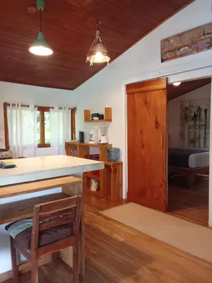 a kitchen with wooden floors and a large counter top at Casa SILURI UP in Santa Teresa Beach