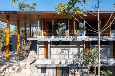 a house with a staircase in front of it at Somos in Santa Teresa Beach
