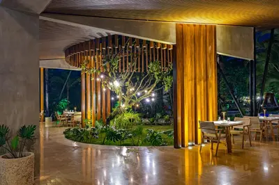 a restaurant with tables and chairs in a room at Noah's Forest by Tifakara in Fortuna