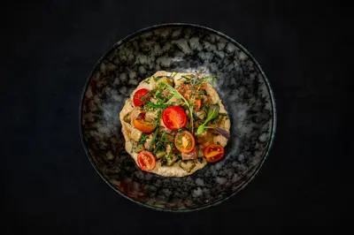 a plate of food with tomatoes and vegetables on it at Noah's Forest by Tifakara in Fortuna