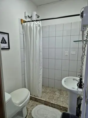 a bathroom with a toilet and a sink at Eco Stay Hostel in San José