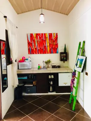 a room with a desk and a painting on the wall at Cabinas D’Val in Uvita