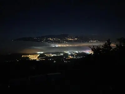 a view of a city at night with the fog at Hotel Vistas del Cielo in Cartago