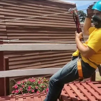 a man sitting on a bench holding a guitar at Hotel Vistas del Cielo in Cartago