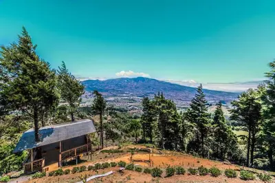 a house on top of a hill with trees at Hotel Vistas del Cielo in Cartago