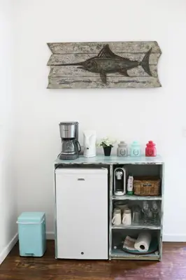 a small white refrigerator in a room with a shelf at Ojochal Gardens in Ojochal