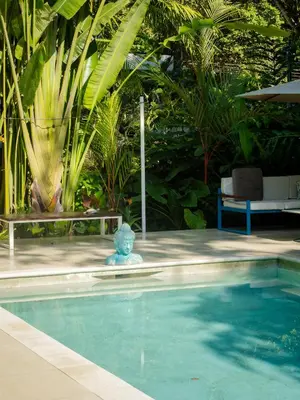 a swimming pool with a statue in the middle of it at Ojochal Gardens in Ojochal