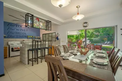 a kitchen and dining room with a table and chairs at Casa Sol in Carrillo