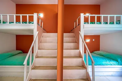 a bunk bed room with stairs and bunk beds at Casa Sol in Carrillo