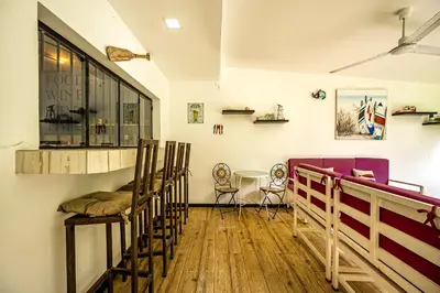 a room with a row of chairs and a table at Casa Sol in Carrillo