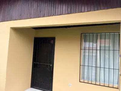 a black door on the side of a building at Casa Hojas in Fortuna