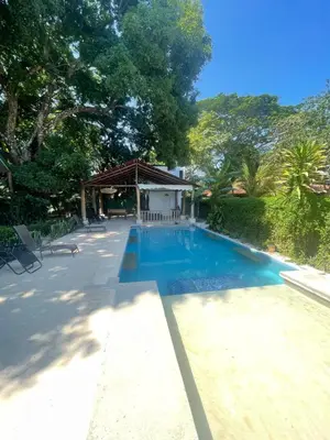 a swimming pool in the middle of a yard at Villas Cabuya Beach & Jungle in Cabuya