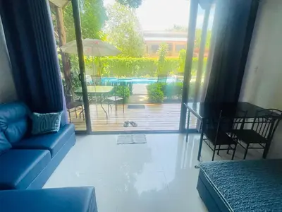 a living room with a couch and a table and a patio at Villas Cabuya Beach & Jungle in Cabuya