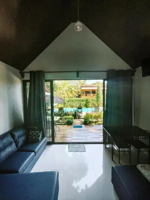 a living room with a couch and a table at Villas Cabuya Beach & Jungle in Cabuya