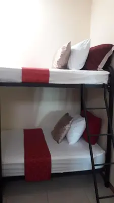 a couple of bunk beds with pillows on them at Flor de Katty Hostel Airport in Alajuela City