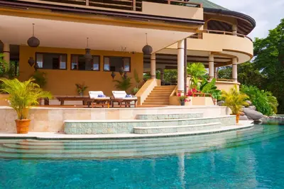 a house with a swimming pool in front of a house at Villa Nimbu in Mal País