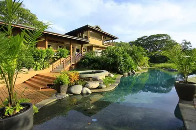 a house with a swimming pool in front of a house at Villa Numu in Mal País