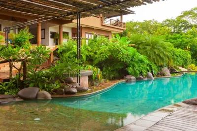 a swimming pool in the middle of a resort at Villa Numu in Mal País