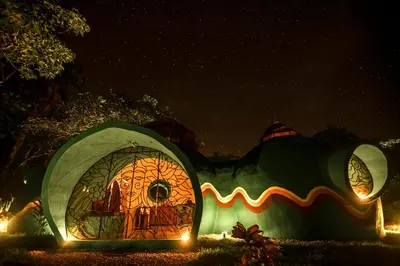 a halloween display of a mushroom house at night at Green Moon Lodge in Montezuma