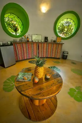 a table with a pineapple on it in a room at Green Moon Lodge in Montezuma