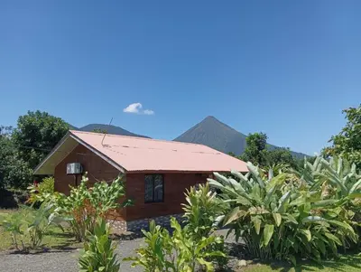 a small house with a mountain in the background at Cabaña Rural el Mirador in Fortuna