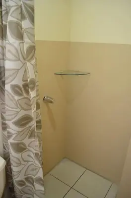 a shower with a glass door in a bathroom at #4 Private room close to Airport in Alajuela City